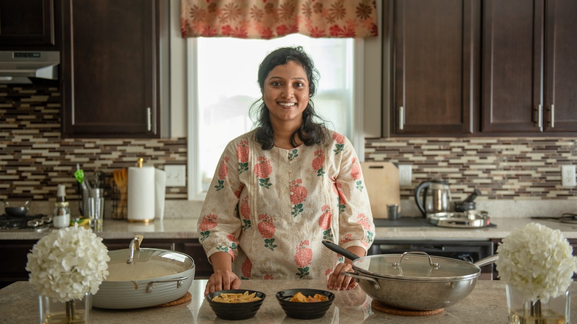 Ananta Vidyarthi smiles while standing in her kitchen, reflecting her people-first approach to leadership at Cummins.