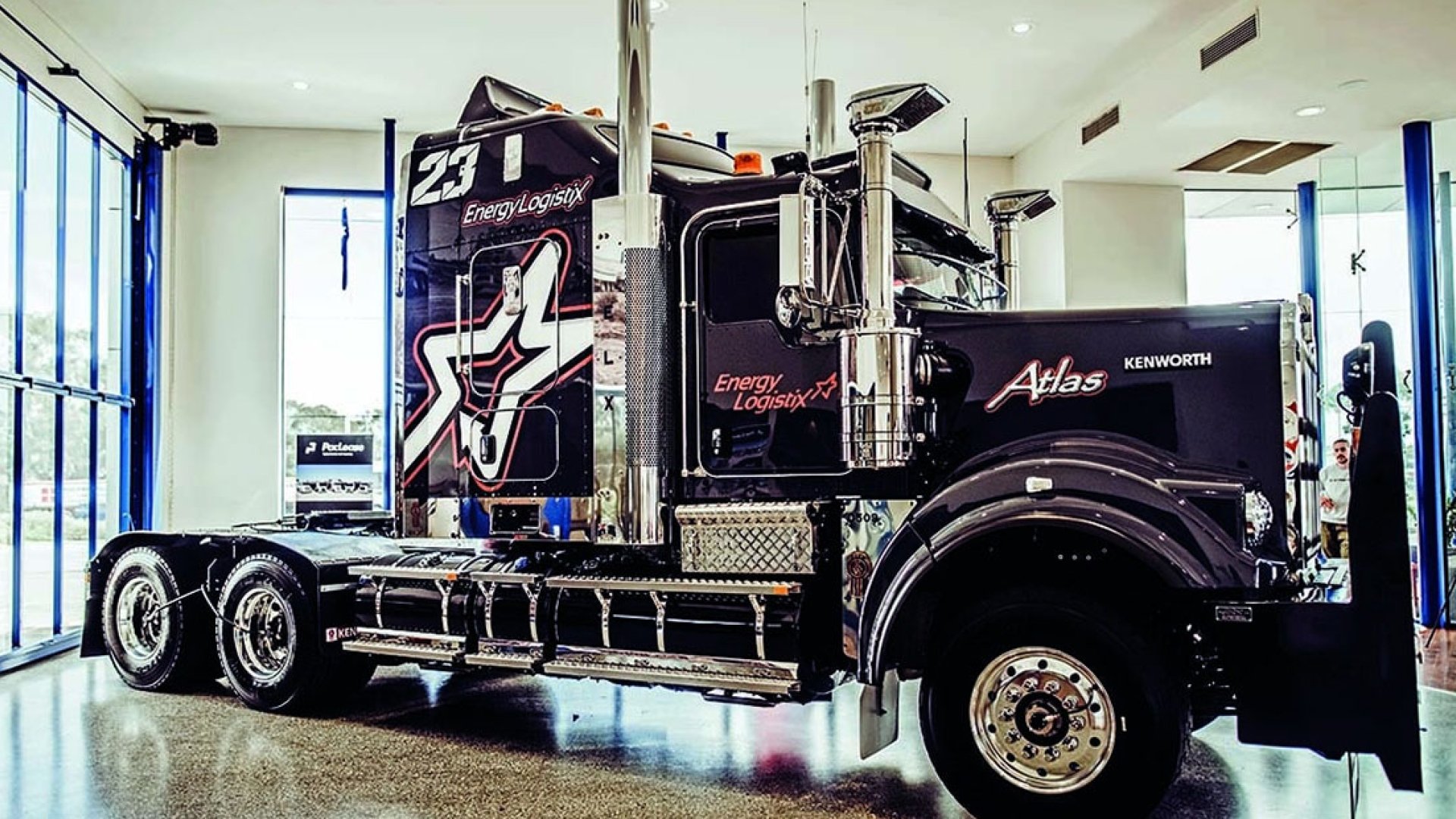 black semi cab on display in a garage