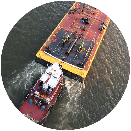 tug boat moving large cargo ship