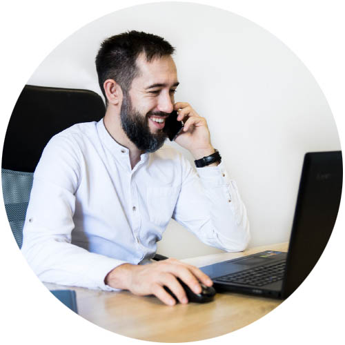 employee talks on phone while working on laptop