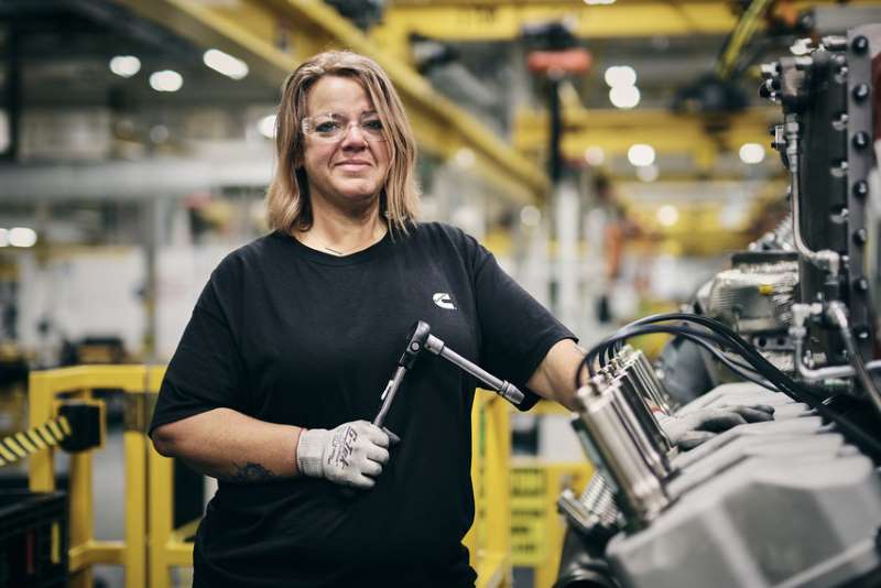 woman employee works on the engine line in cummins factory