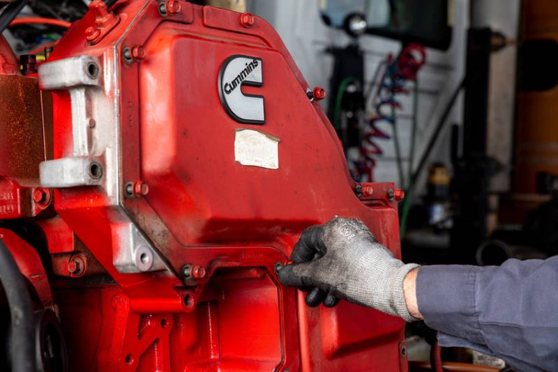 technician adjusting engine parts