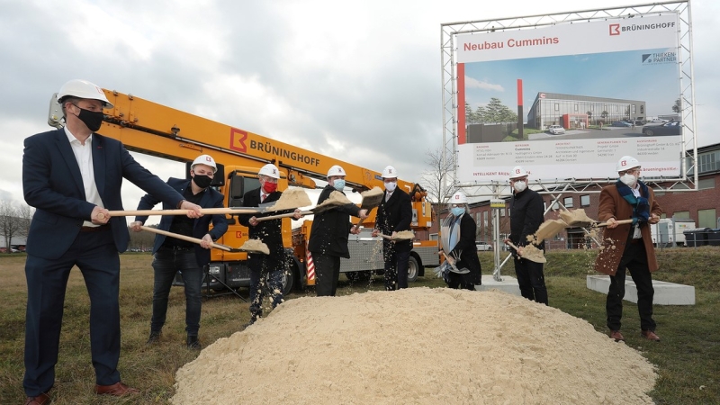 employees digging at groundbreaking ceremony