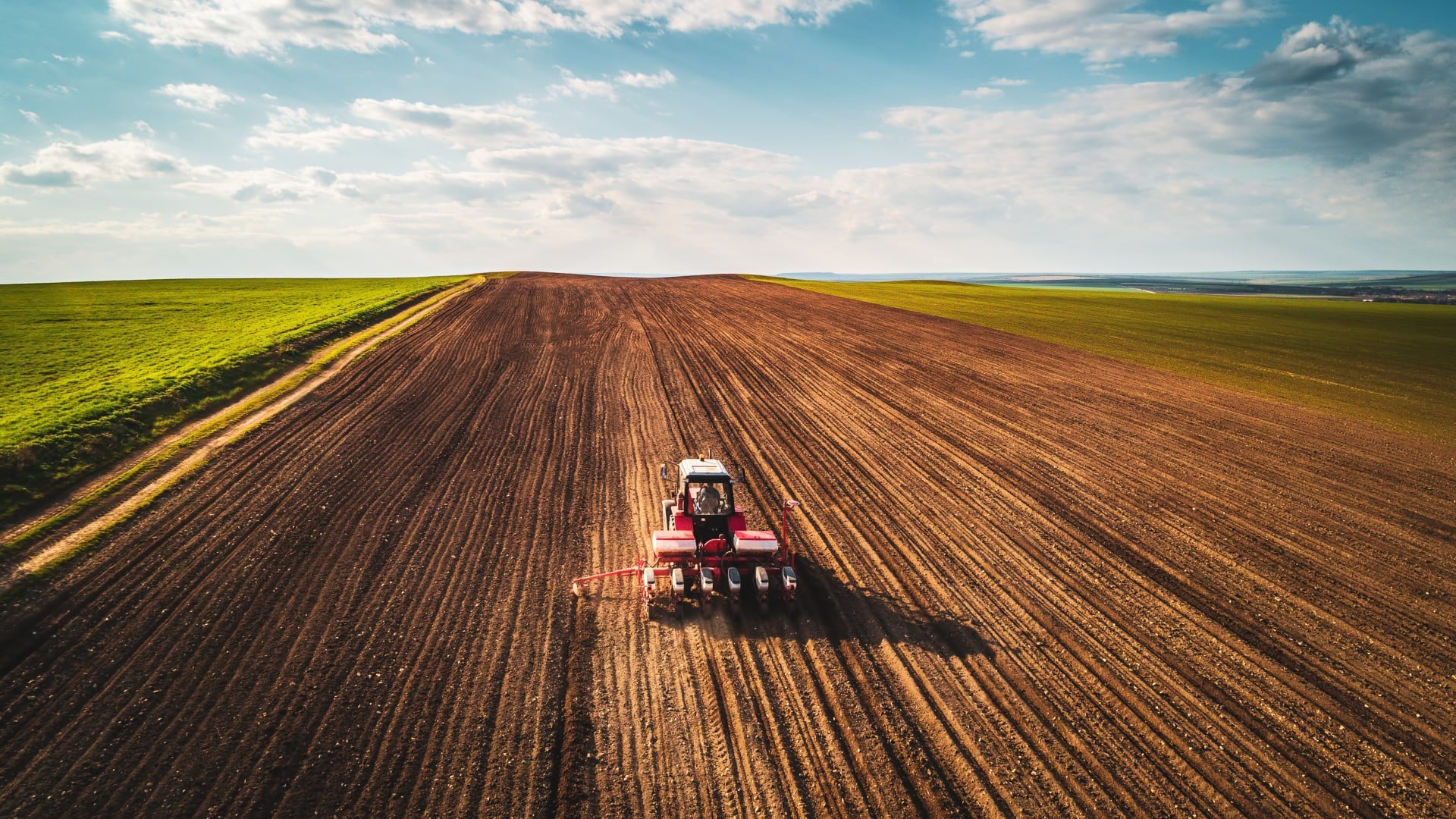 Farmer in a tractor harvesting crops