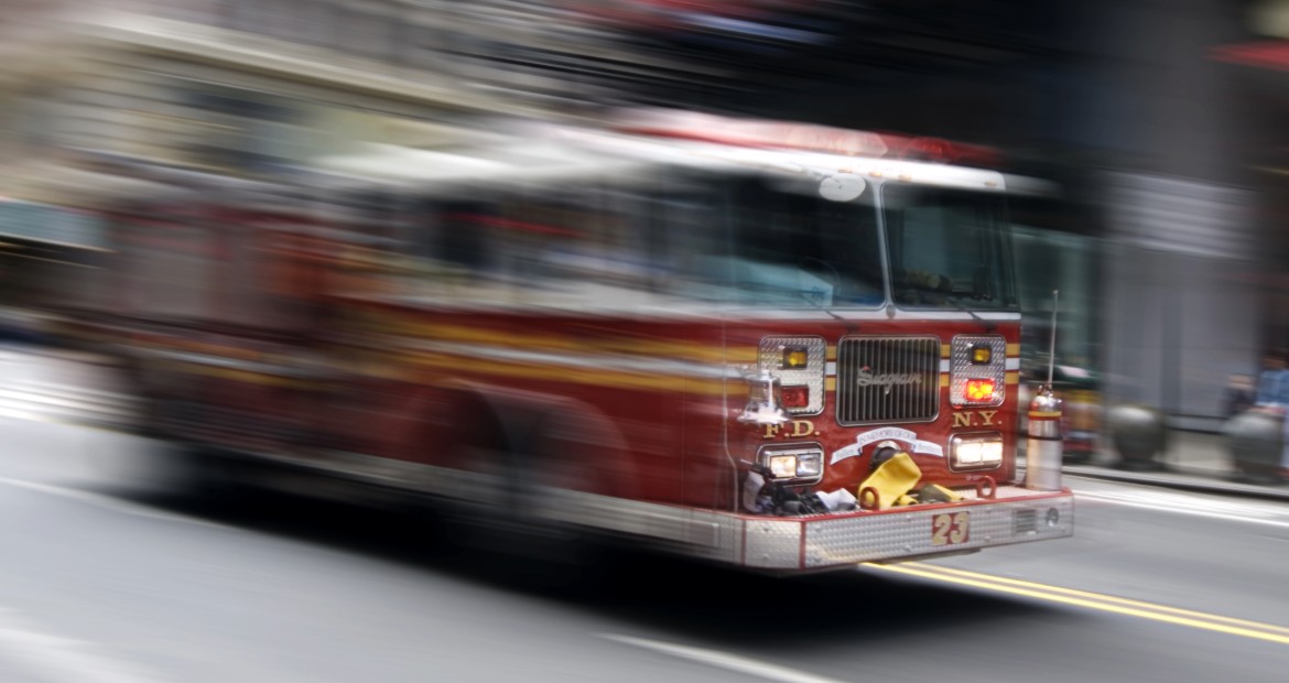 Camion de pompiers traversant une rue de la ville