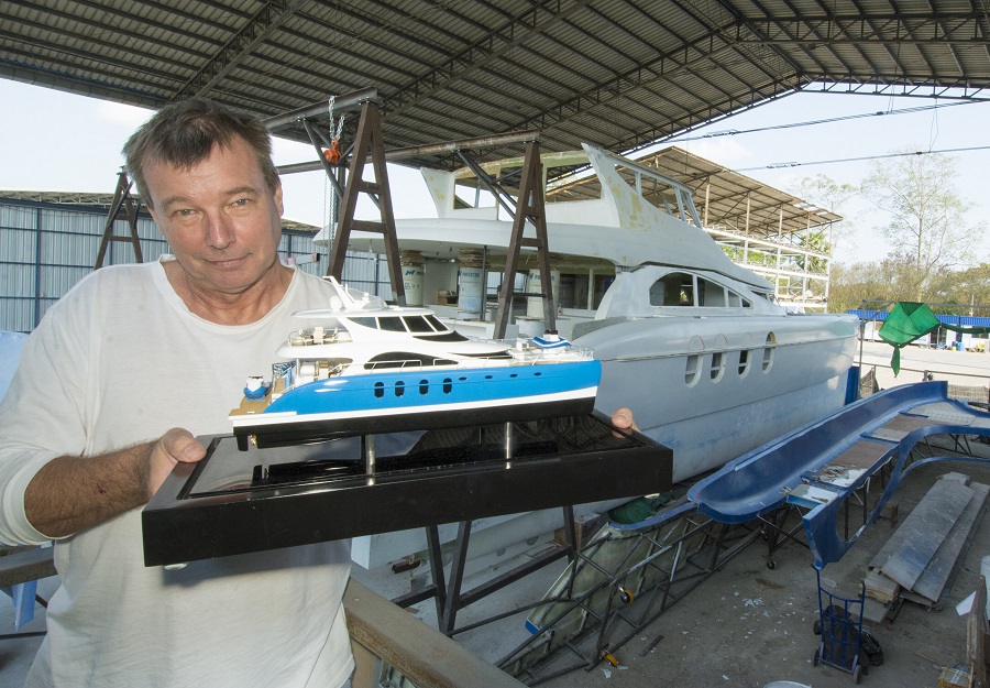2. James Dewing with a model of his catamaran that he has exhibited at shows around the globe.