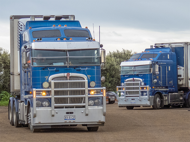 blue semi trucks parked