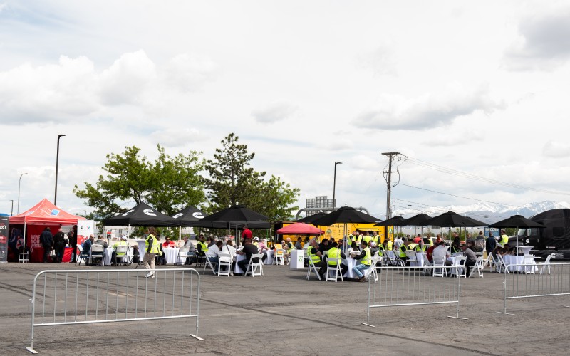People sitting under Cummins branded tents at the Forever Rising Tour