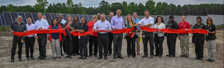 employees at a ribbon cutting ceremony