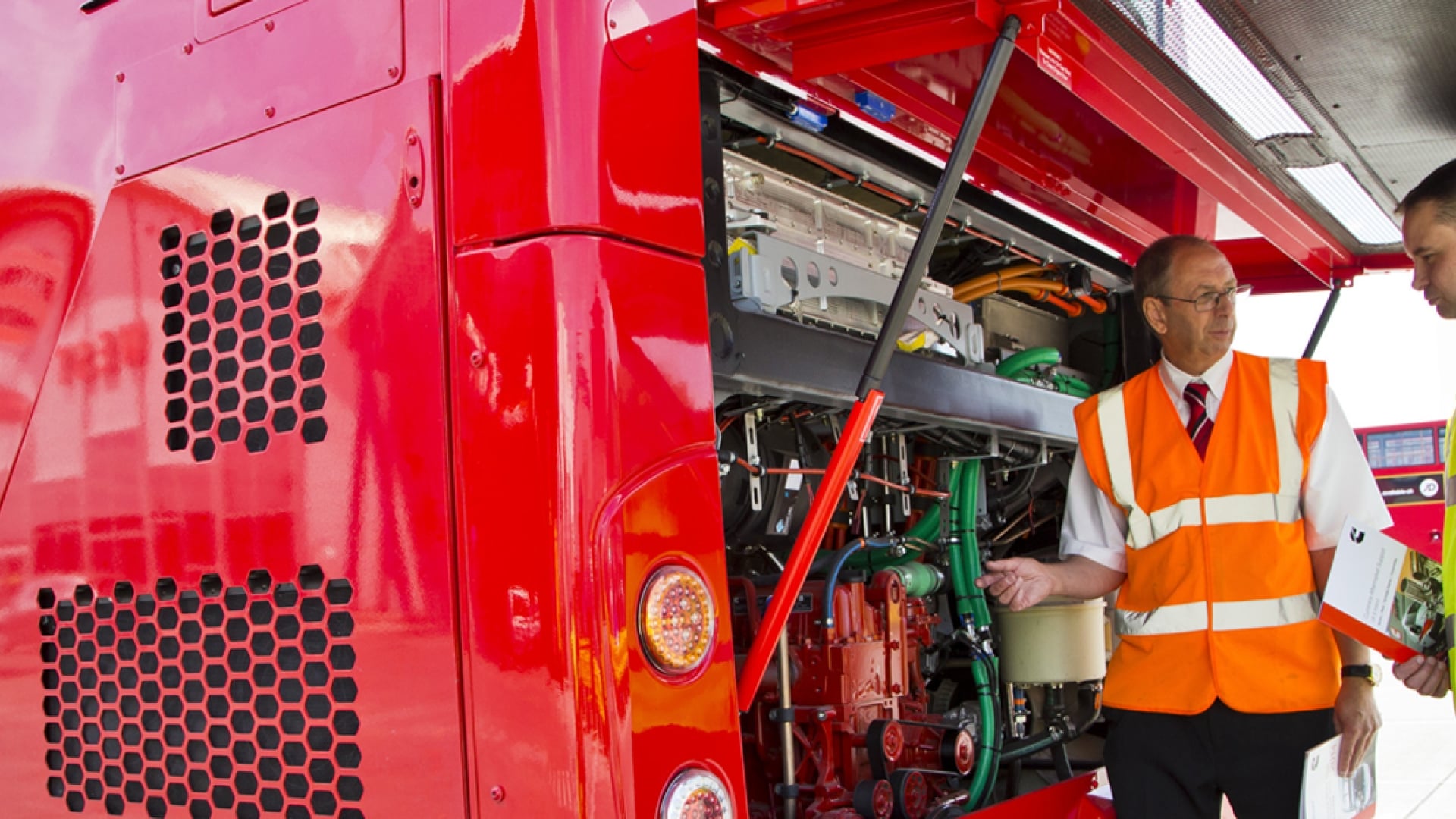 men inspecting euro bus engine