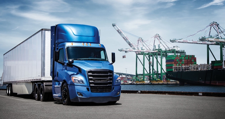 Blue and white Freightliner next to construction equipment