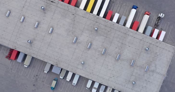 Trucks parked outside a building in a row