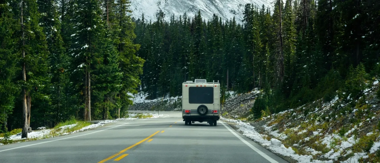 RV driving on forest mountain road