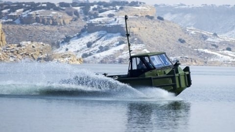 military boat driving on lake