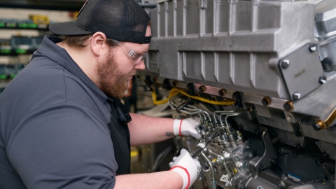 Cummins technician using tools to service an engine