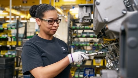 Cummins team member tightening components on an engine