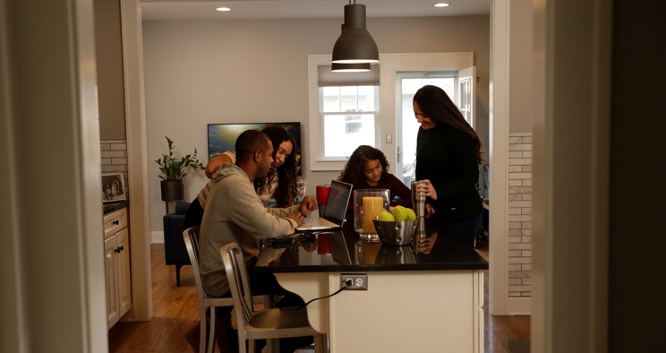 Family around a table in their home