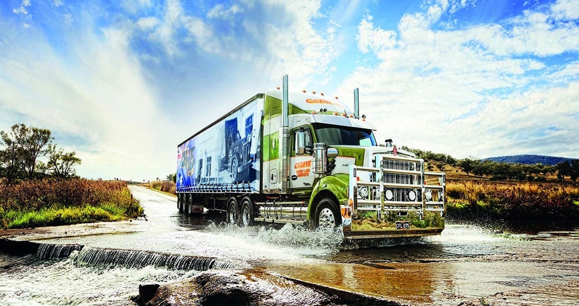 semi truck driving through water