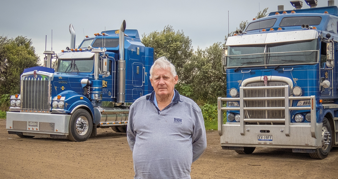 Shane standing in front of semis