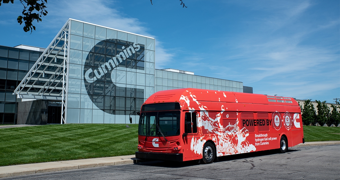 Cummins bus parked by plant facility