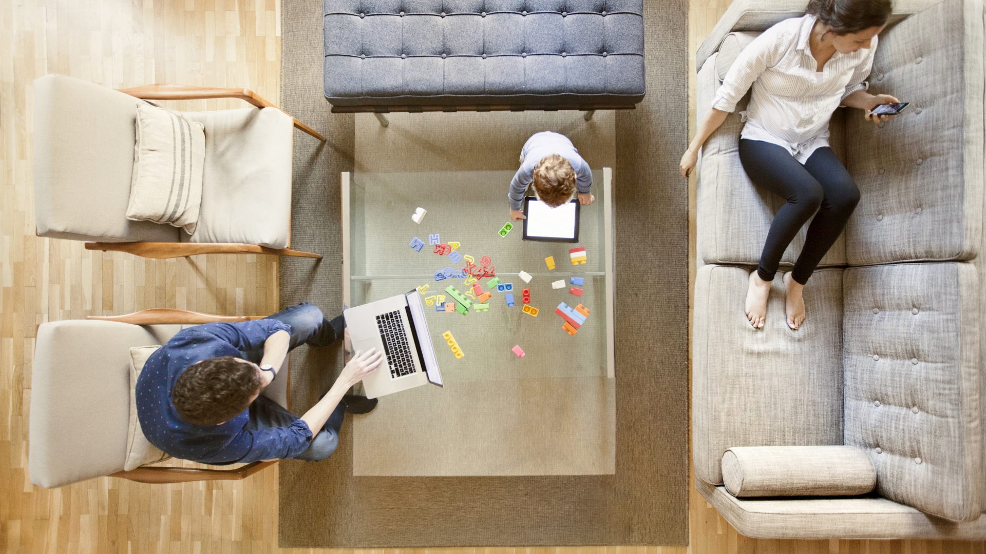 Family using technology in living room