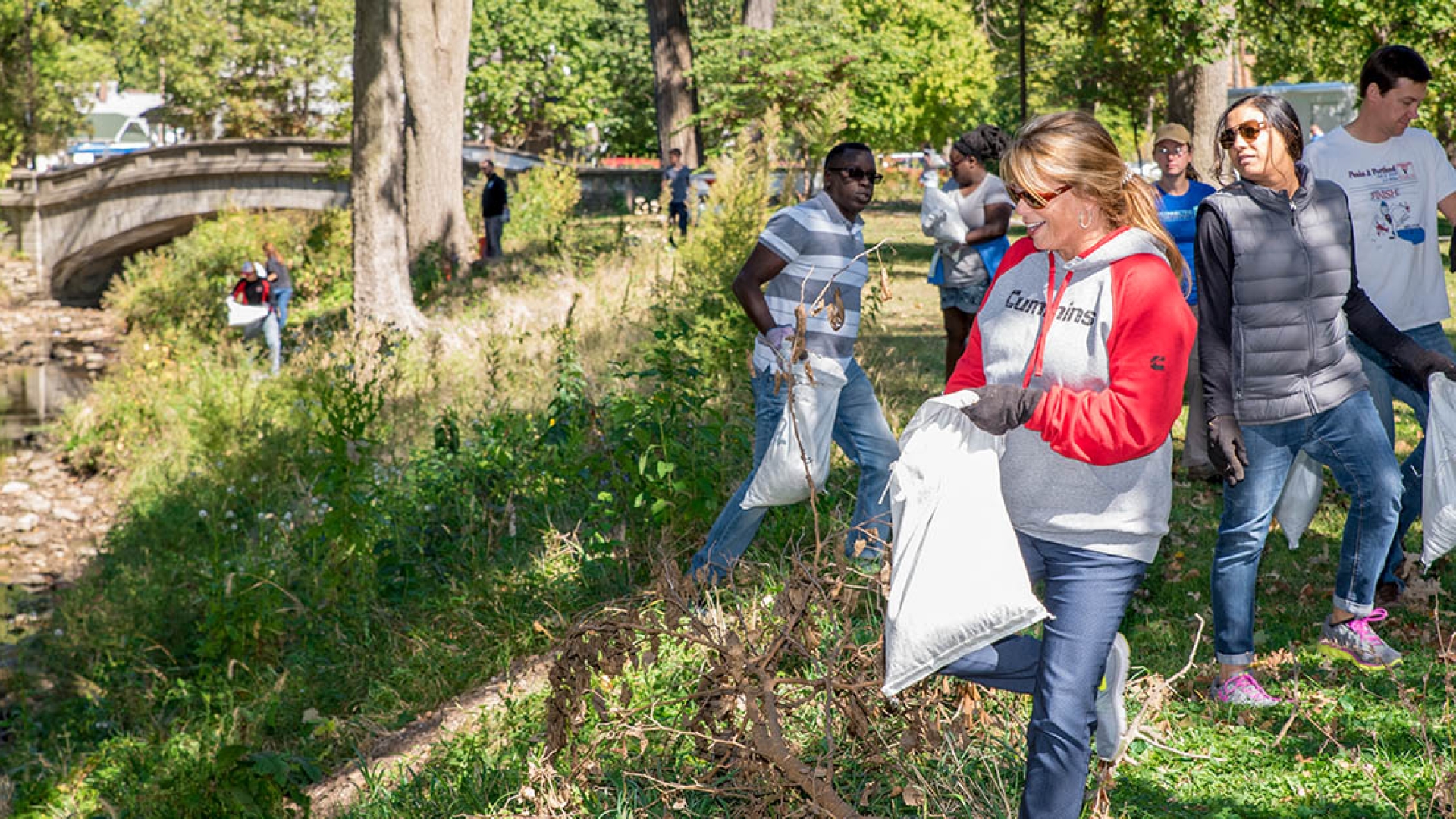 Employees cleaning a park