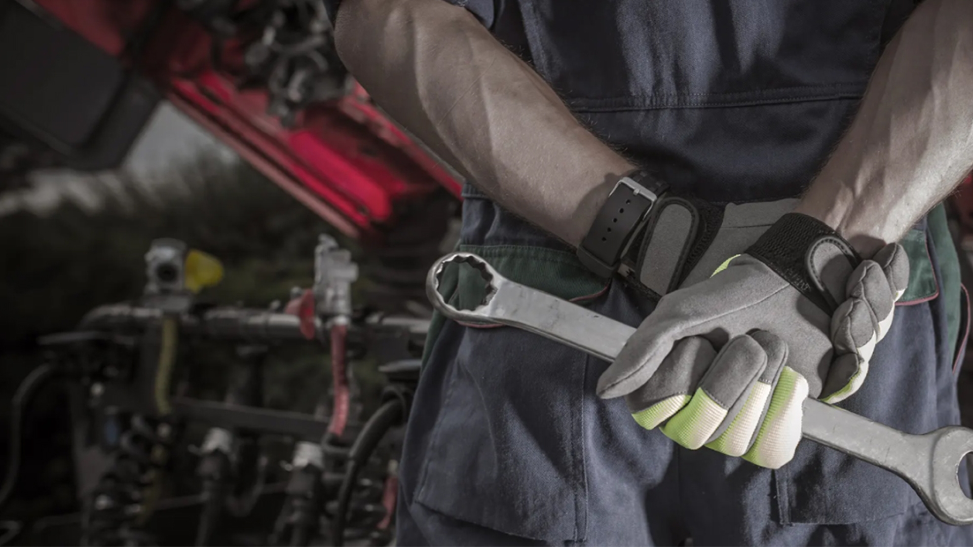 Person holding wrench behind back