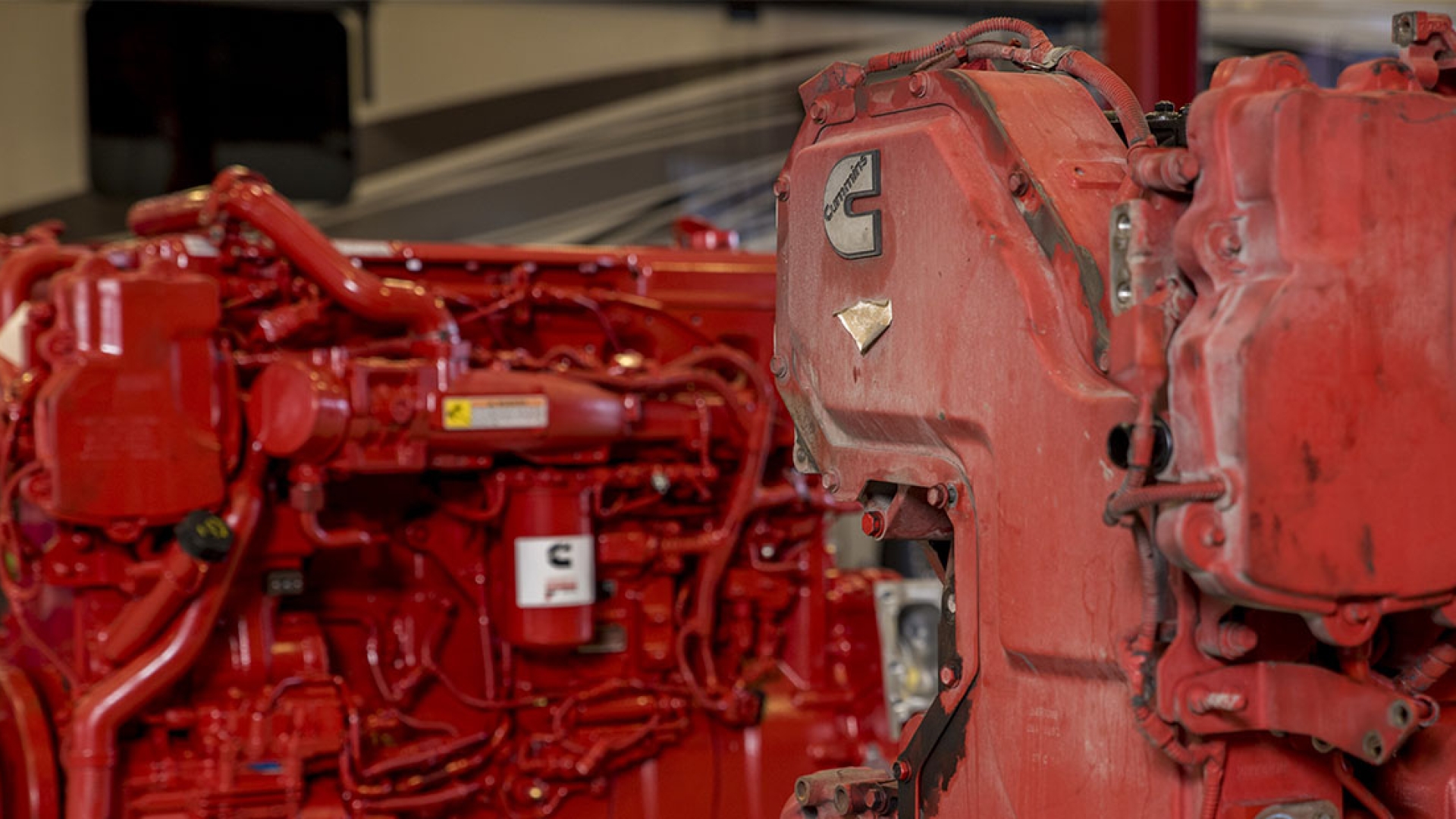 2 red Cummins engines side-by-side, one before and one after remanufacturing