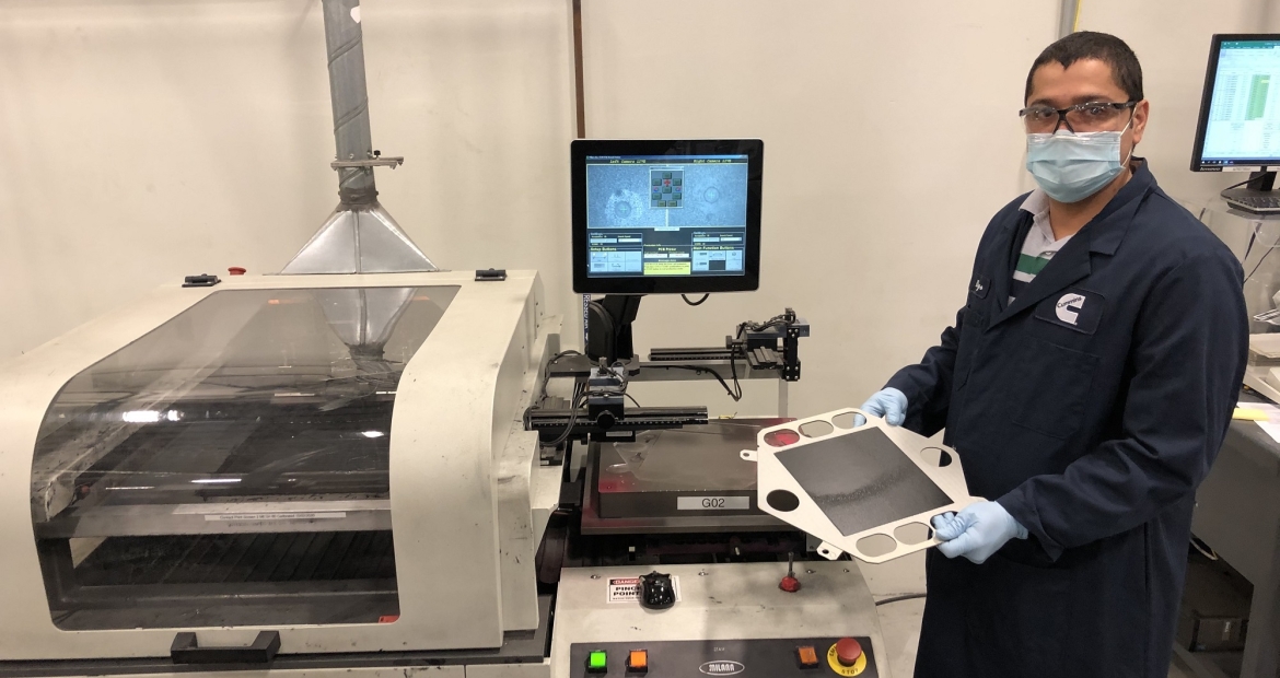 A Cummins employee works on the cathode screen printing process, towards the end of the solid oxide fuel cell manufacturing line at the company's facility in Malta, New York (U.S.).