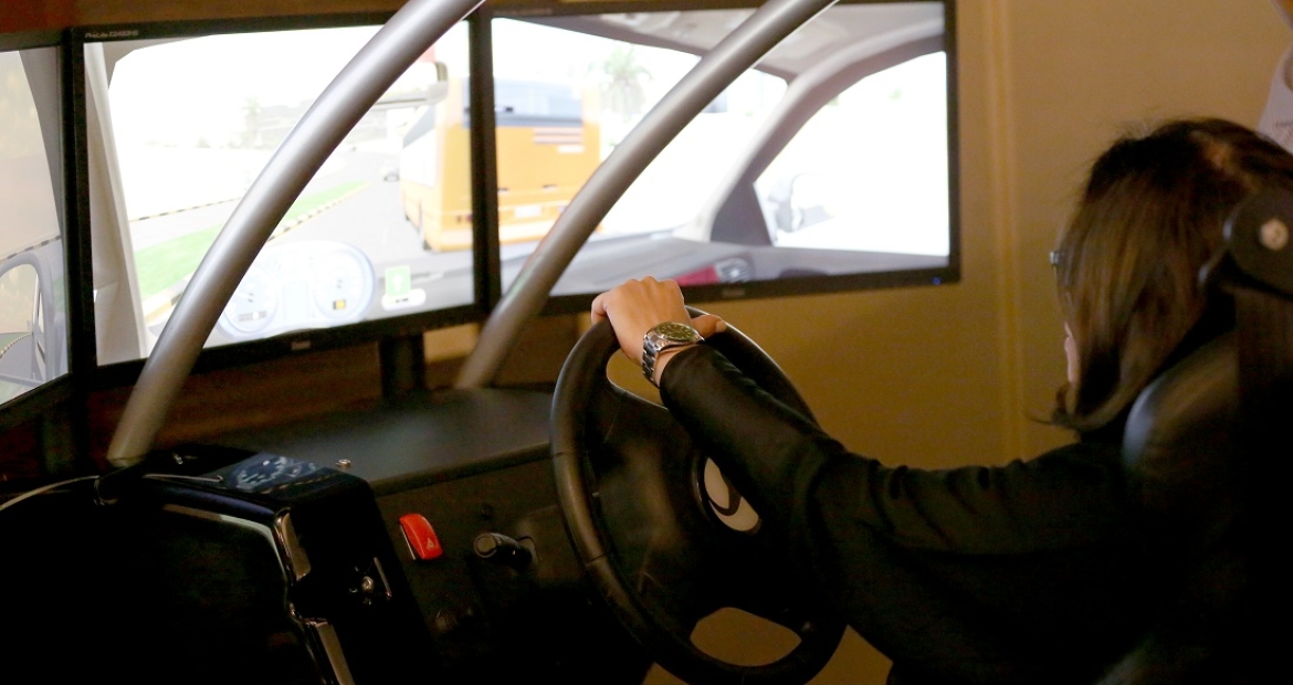 A participant uses a driving simulator at one of the workshops sponsored by Cummins and its joint venture partner Olayan. A participant in one of the workshops sponsored by the Cummins and its joint venture partner Olayan learns about driving by using a simulator provided by the program.