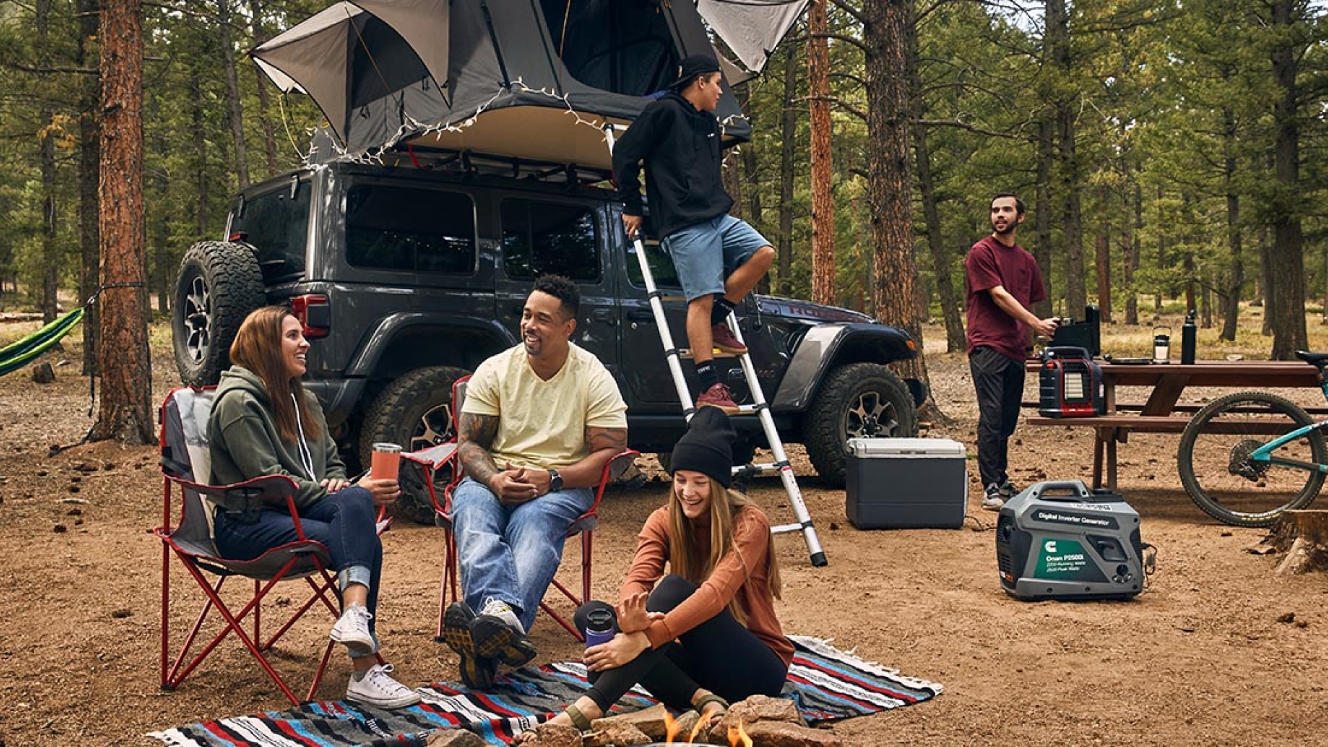 Friends around the fire at a campsite