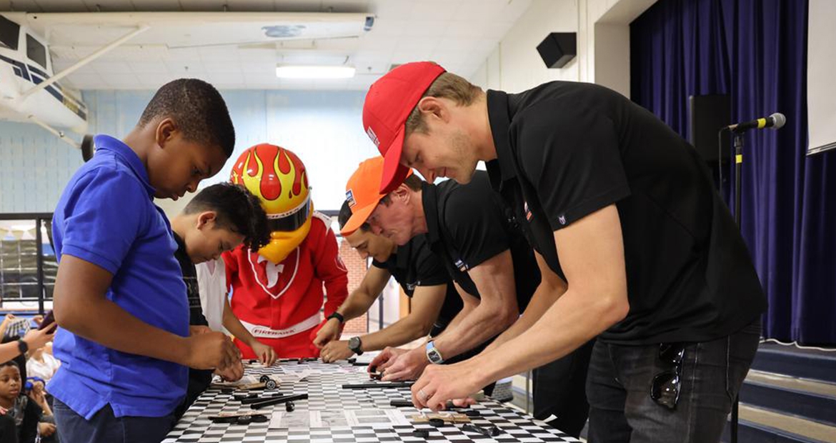 IndyCar drivers building cars with students