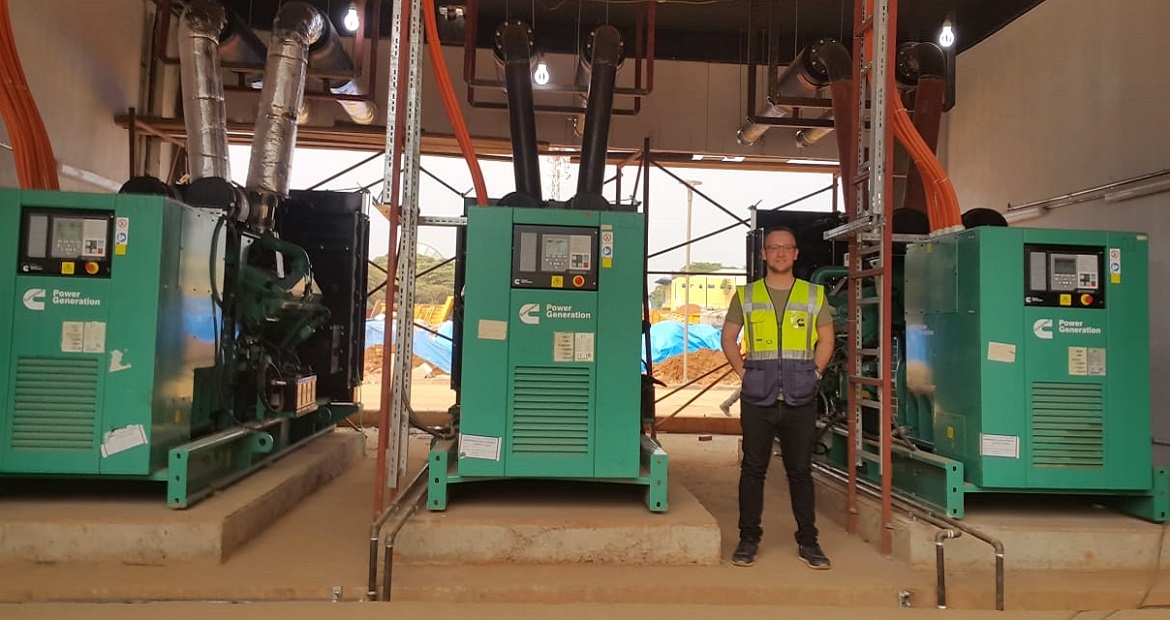 Adem Ersoy, Project Engineer at Cummins Turkey's authorized distributor Mepa Energy, stands next to the standby power system at Kigali Arena. Adem Ersoy, Project Engineer at Cummins Turkey's authorized distributor Mepa Energy, stands next to the standby power system at Kigali Arena.