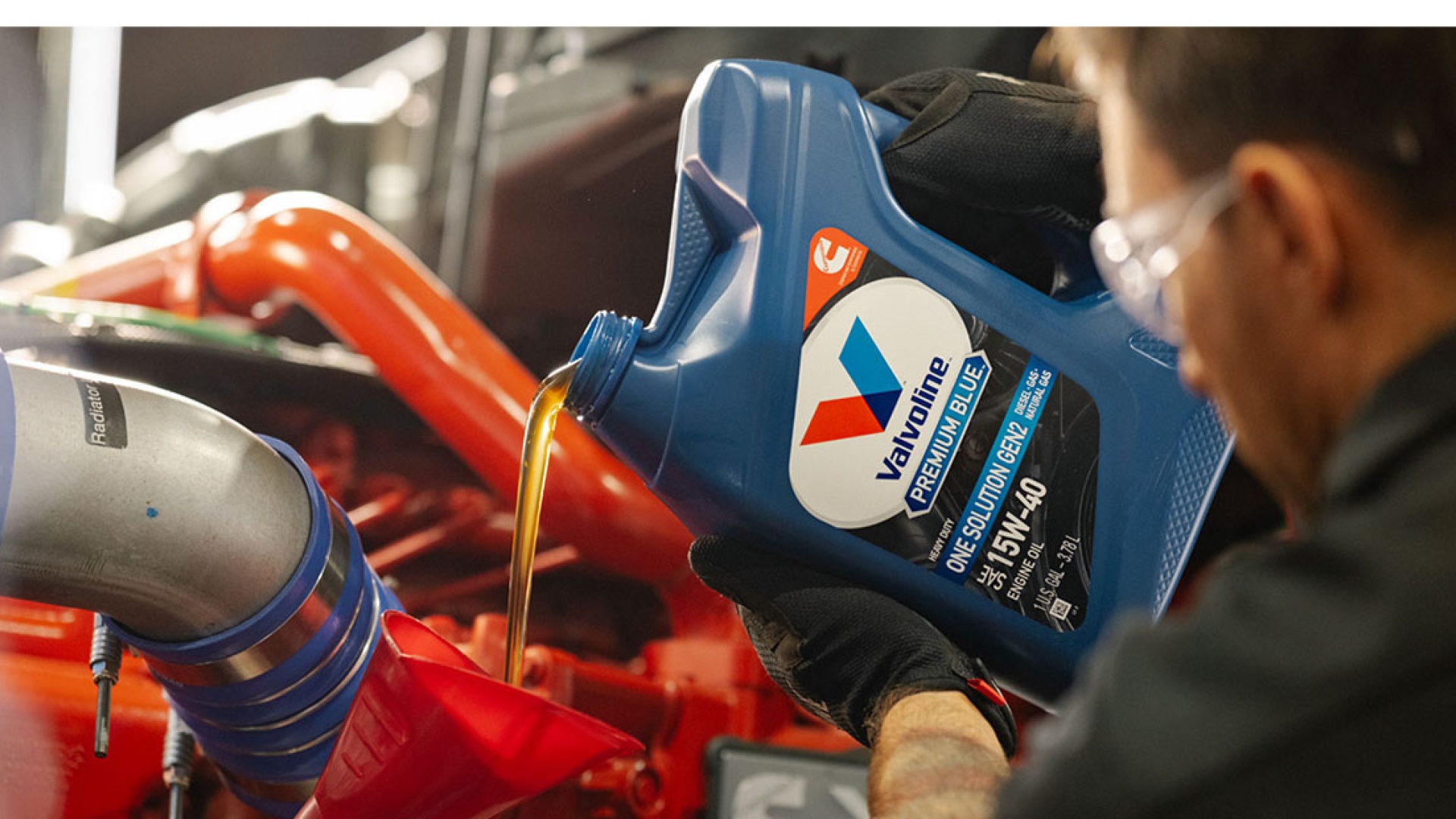 Employee pouring Valvoline oil into application