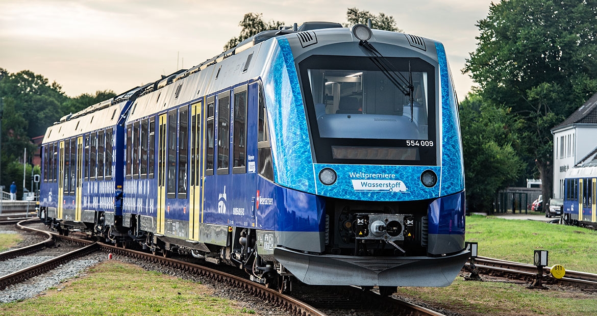 blue electric train on tracks