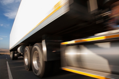 Closeup of heavy-duty truck going down the road