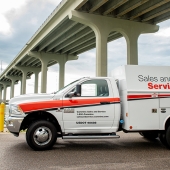 Sales and Service truck parked by bridge