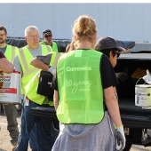Cummins employees at the Columbus Engine Plant unload waste paint at a community recycling day at the plant earlier this year.