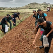 Cummins employees work on a grass-seeding project to help a community conserve water in India. This photo was taken prior to the COVID-19 pandemic.