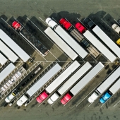 Heavy duty trucks parked diagonally in a parking lot