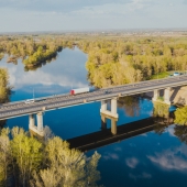 semi driving over a bridge over a river