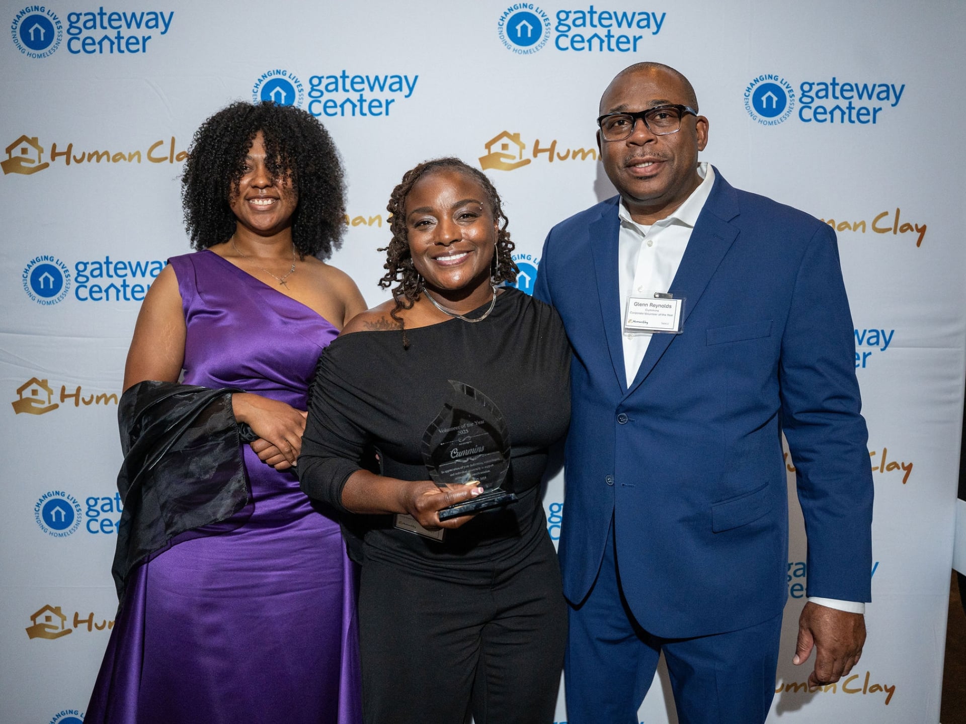 Meko holds an award at a Gateway Center community recognition event in Atlanta.