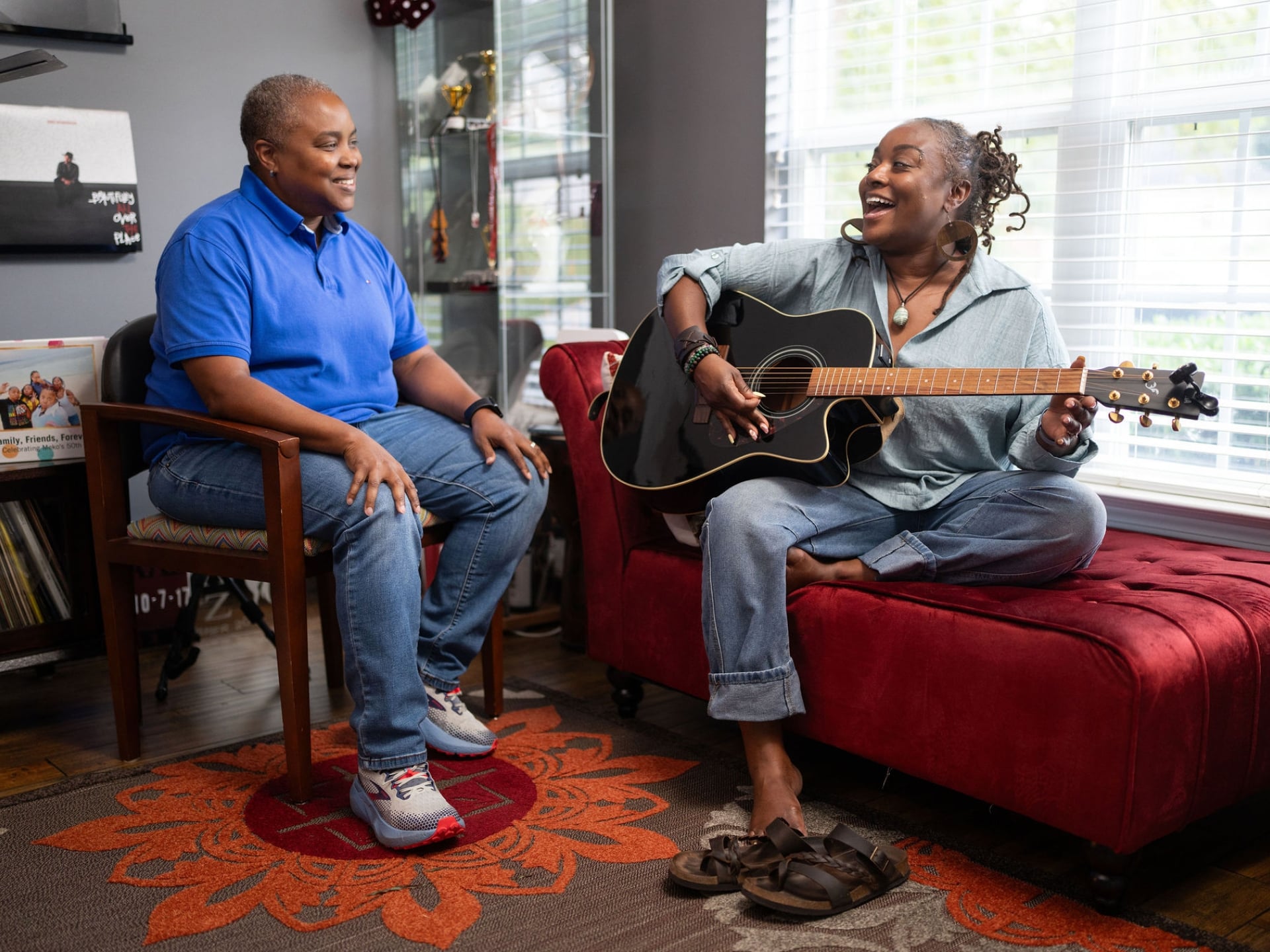 Meko Taylor plays guitar with her family at home.