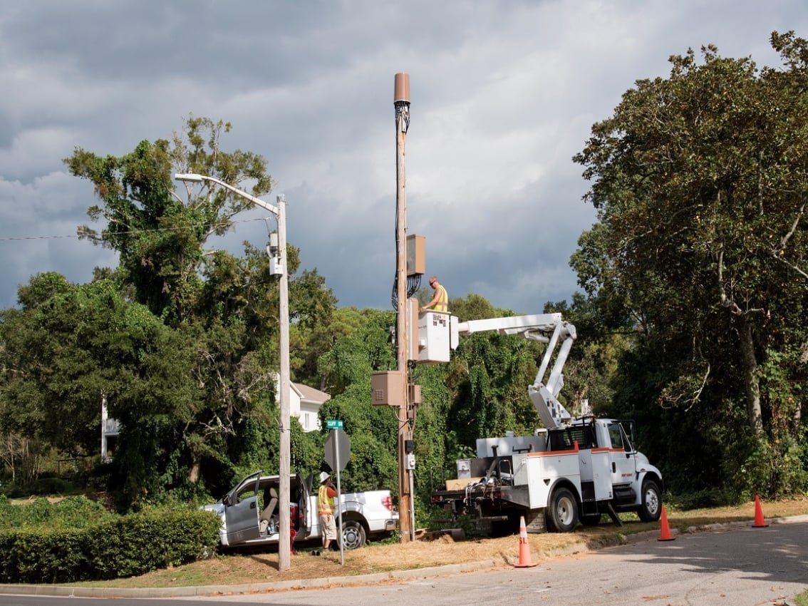 Workers working on bucket truck