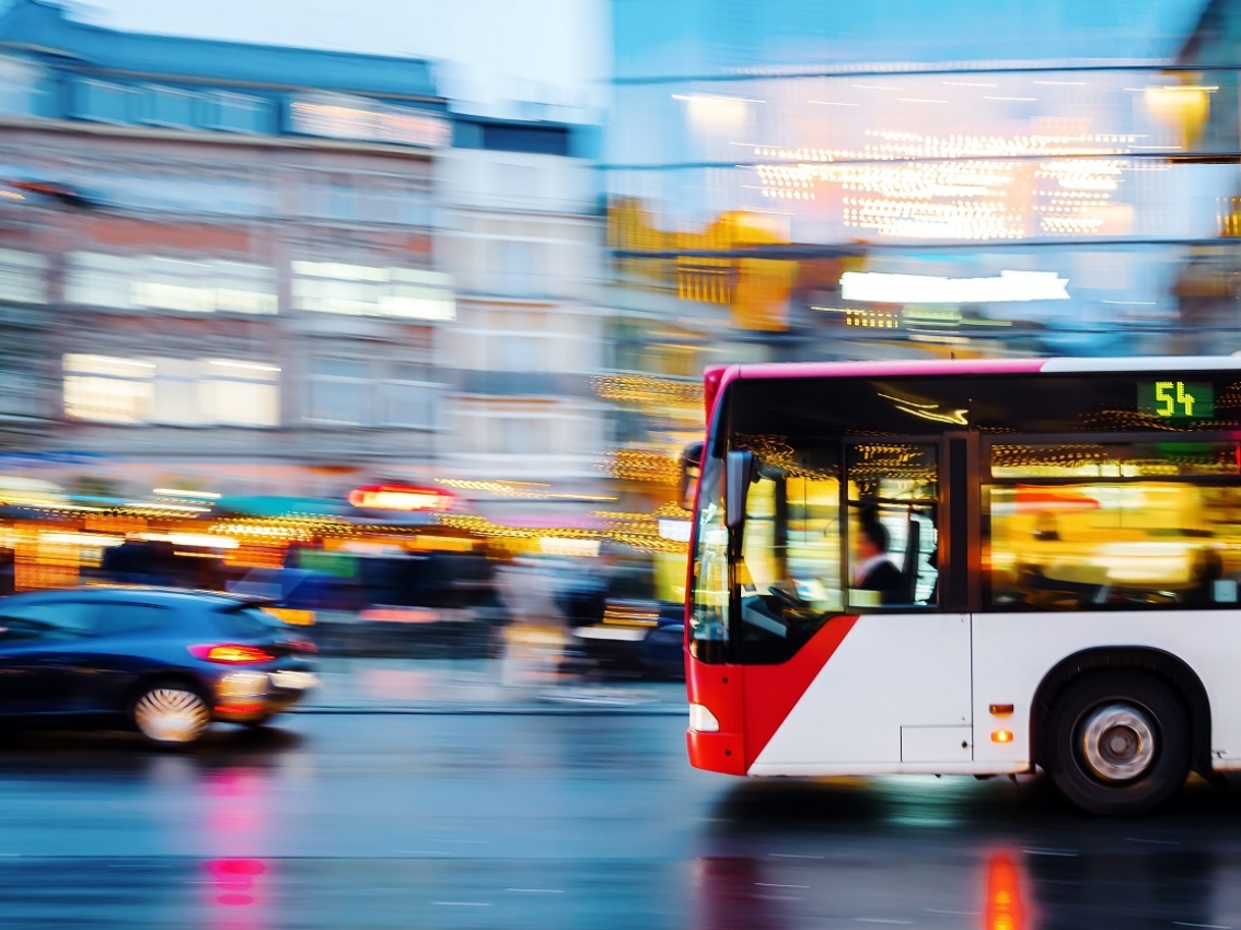 Transit bus driving through a city